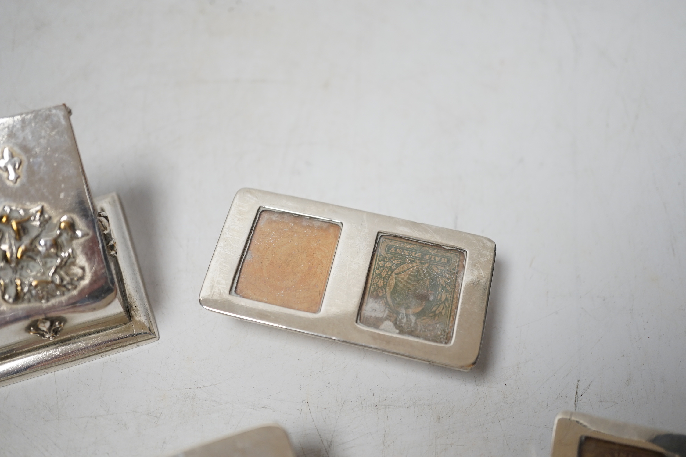 Four assorted late 19th/early 20th century silver stamp boxes, including triple compartment, one with enamelled 'stamps', largest 9cm and one plated stamp box.